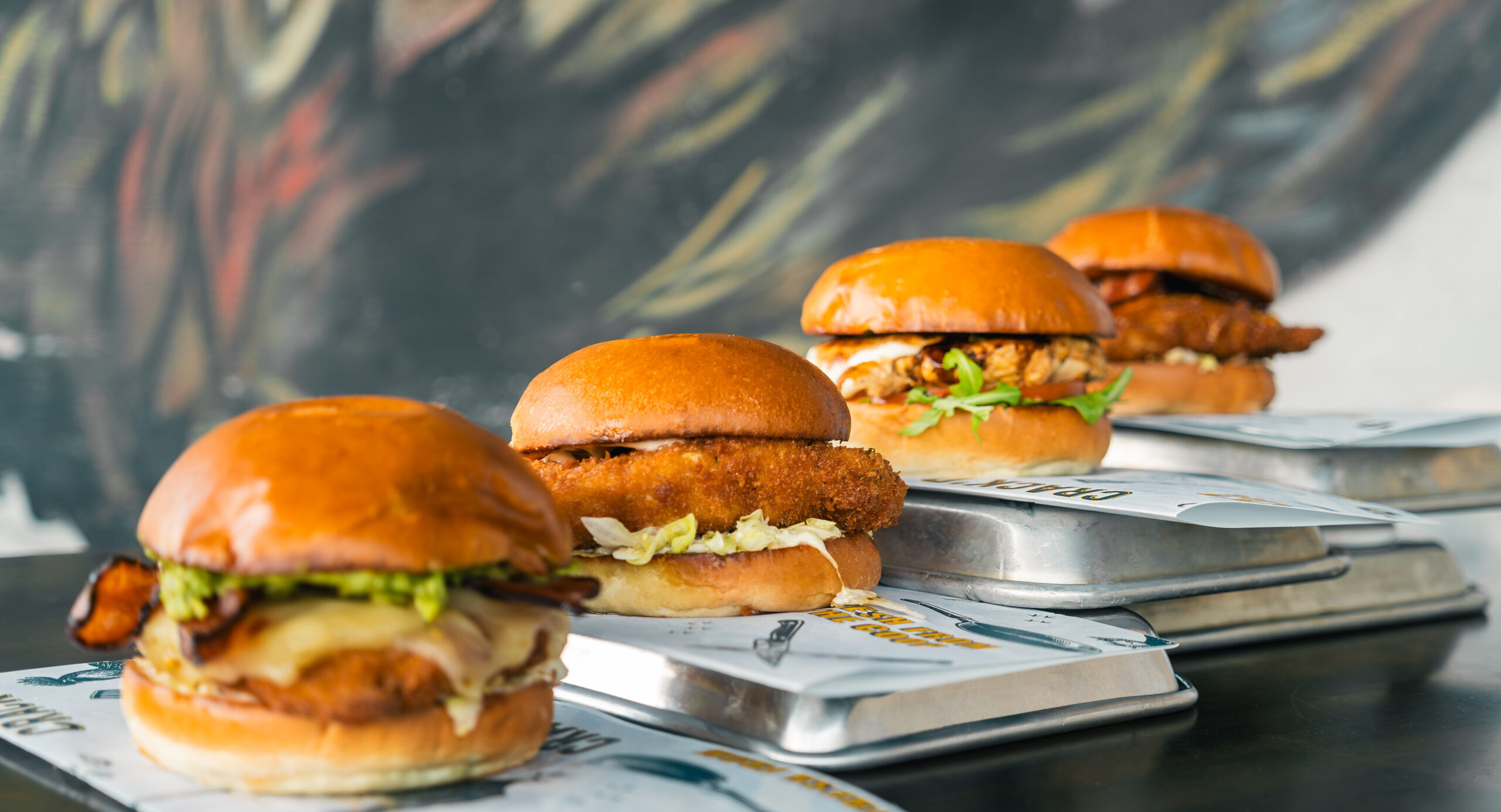 Various sandwiches from CRACK’D on soft buns.